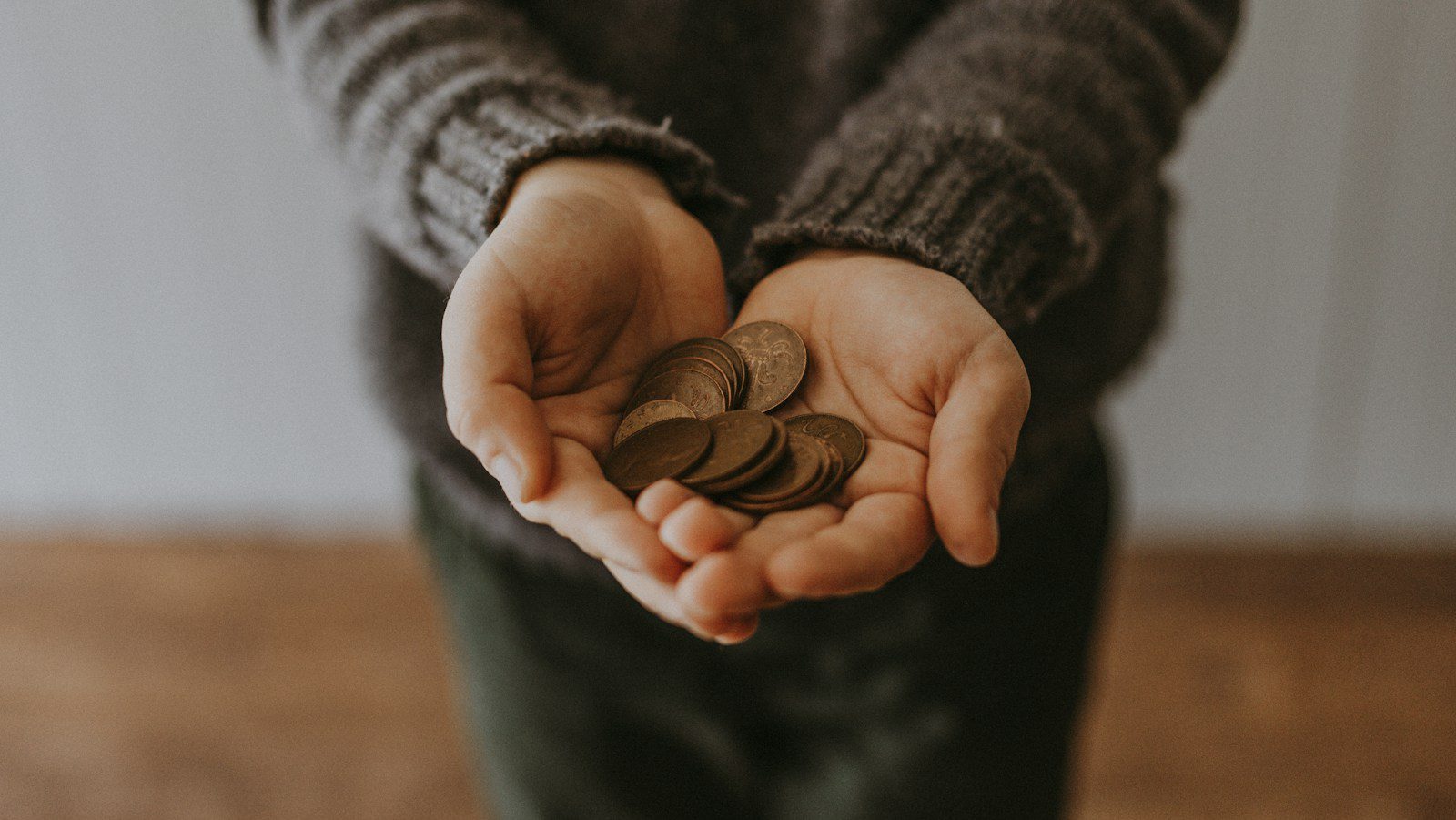 copper-colored coins on in person's hands